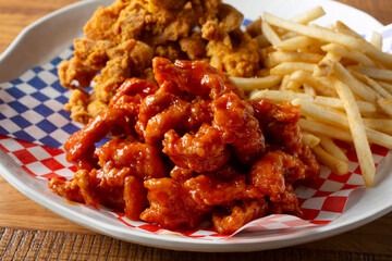A closeup view of a platter of two kinds of Korean fried chicken.