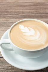 A view of a latte coffee drink, featuring latte art.