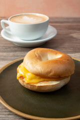 A view of an egg and cheese bagel sandwich.