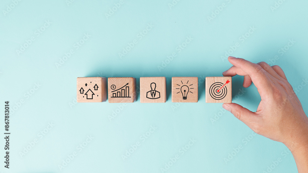 Poster hand holding block with red arrow on target center point line up with lightbulb, businessman, graph 