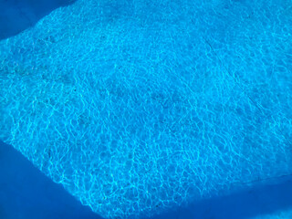 There are ripples of water in the blue pool.