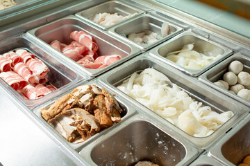 A view of a steamer table full of assorted ingredients. 