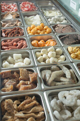 A view of a steamer table full of assorted ingredients. 