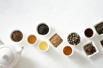 A top down view of assorted loose leaf tea and tea liquor, on the bottom of the frame.