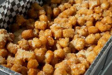 A view of a catering tray of garlic tater tots.
