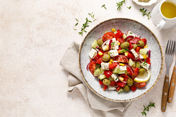 Salad with feta cheese, olives and fresh vegetables, top view