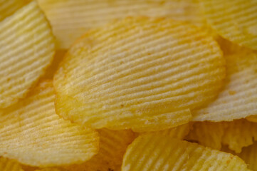 A stack of potato chips, a popular junk food, placed