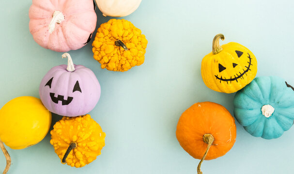 Pastel color jack o lantern and decorative pumpkins with copy space. Thanksgiving and Halloween background.