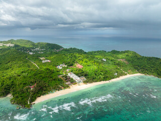 Drone view of beach resorts with ocean waves and white sand. Ilig Iligan Beach. Boracay,...
