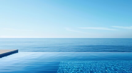 A luxurious infinity pool overlooking a serene ocean, with the water reflecting the clear blue sky