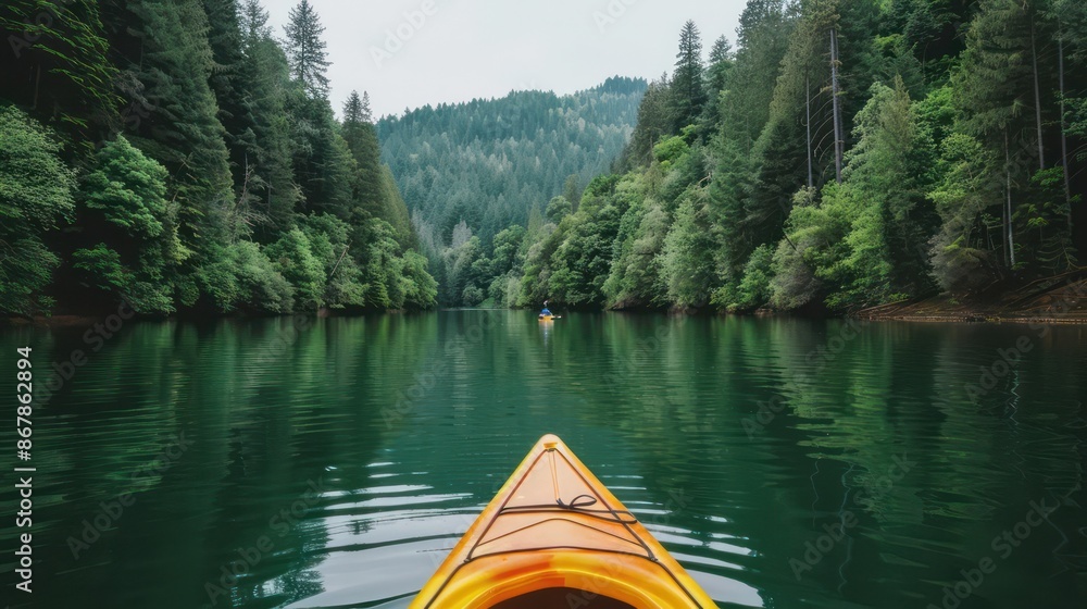 Aufkleber a kayak is floating on a lake with trees in the background. the water is calm and the sky is cloudy