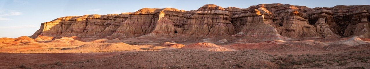 Fototapeta premium The rock formation of the white stupa, also known as Tsagaan Suvarga, shines in the last beams of the setting sun