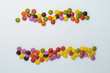 Sugar-coated chocolate on a white background. Copy space.