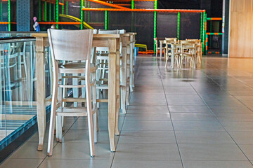 bar tables and tables in the interior near the cinema. Modern interior