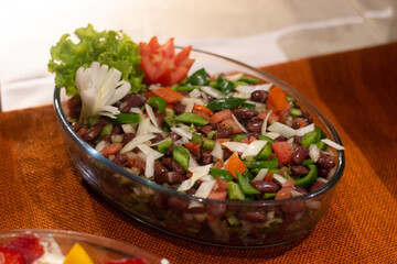 black beans salad decor with tomato flower and salad leave