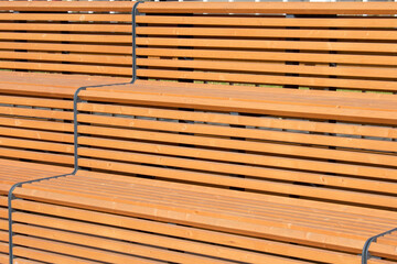 wooden sports stands , benches in the outdoor park closeup