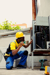 Knowledgeable professional commissioned for routine condenser cleaning, using dusting brush to...