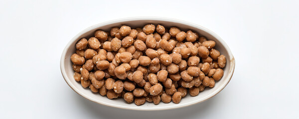 Top-down view of dry dog food laid out neatly in a ceramic bowl, isolated against a dark white background