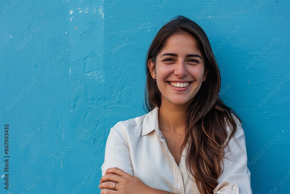 Wall mural Smiling Young Woman Portrait Blue Wall Background