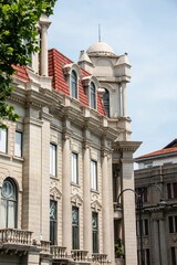Historic European-style building with red-tiled roofs and ornate details in Wuhan, China