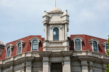 Obraz premium Historic European-style building with red-tiled roofs and ornate details in Wuhan, China