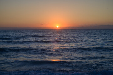 Obraz premium Sunset over island on Mediterranean Sea during summer season