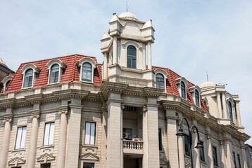 Historic European-style building with red-tiled roofs and ornate details in Wuhan, China