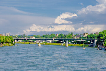Fototapeta premium Basel city- A bridge spans Rhein river with a city in the background
