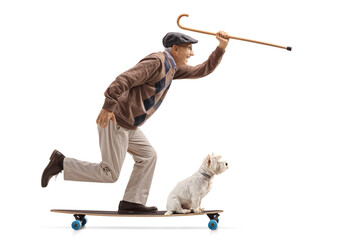 Full length profile shot of a senior man with a dog riding a longboard