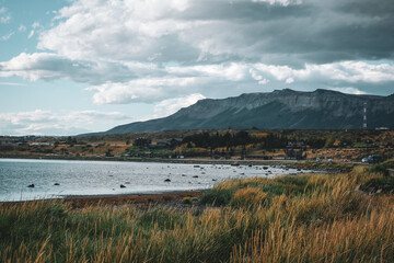 Puerto Natales Muelle Viejo Coast line argentina riverbank grass Golfo Almte Montt sky clouds