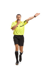 Football referee walking and blowing a whistle