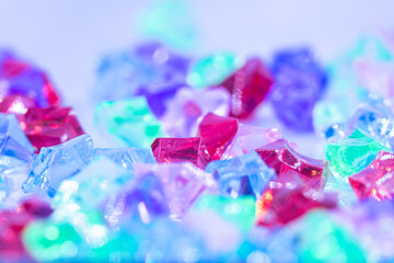 A bunch of colorful gems are scattered on a white background