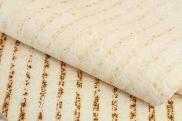 Tasty thin lavash as background, closeup