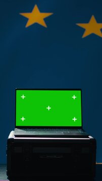 Vertical video EU alliance engineer uses green screen laptop to protect against fake accounts on social media. Technician doing cybersecurity job for European Union with mockup notebook, camera B