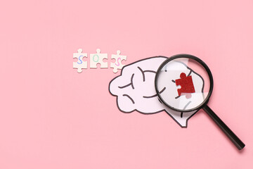 Paper brain with word SOS, magnifying glass and puzzle piece on pink background. Multiple Sclerosis...