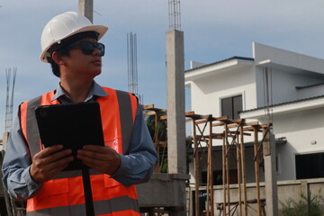 A team of engineers inspects beam work and installs concrete pillars according to the blueprint.