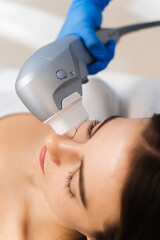 Attractive girl is having facelift procedure in cosmetology clinic. Ultraformer nonsurgical...