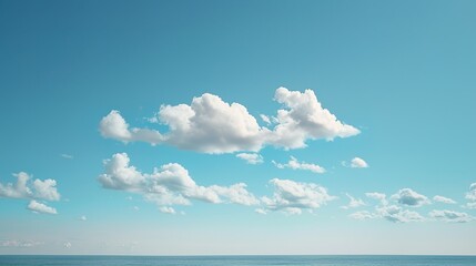 Obraz premium Tranquil Blue Sky with Soft White Clouds Over Vast Empty Horizon