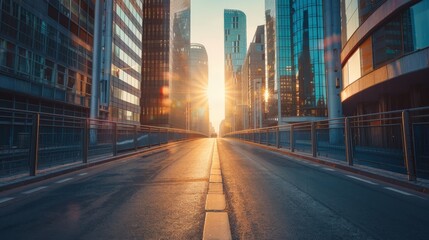 Empty urban road at dawn with skyscrapers casting long shadows