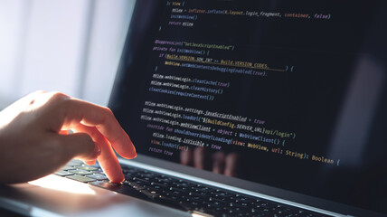 Computer programmer, software engineer typing, coding javascript on laptop computer, software...