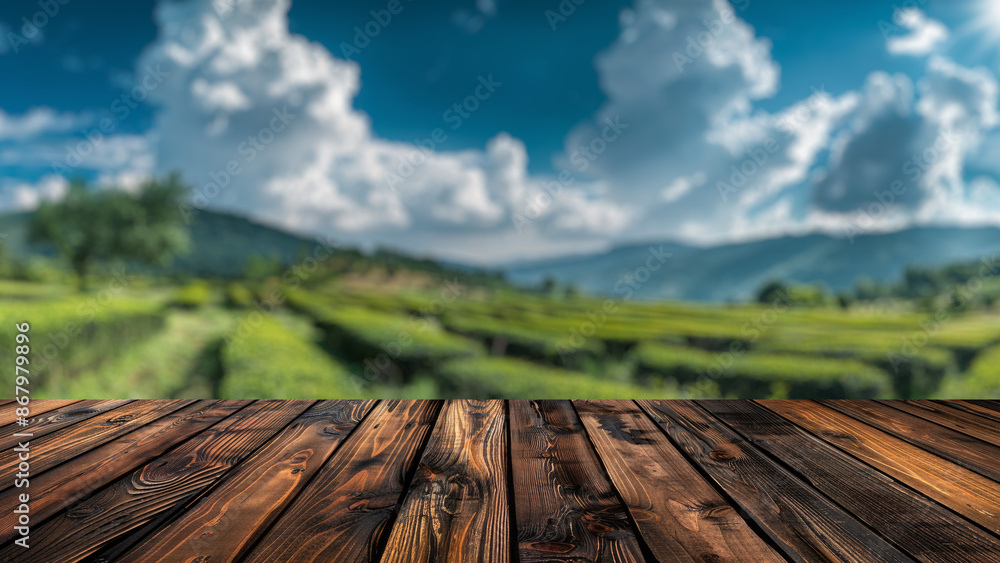 Poster empty wood table top with blur background of tea plantation field. the table giving copy space for p