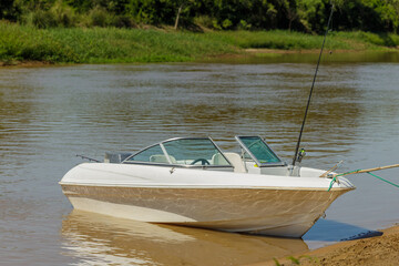Fishing boat moored on the shore of the Parana River in Santa Fe, Argentina.