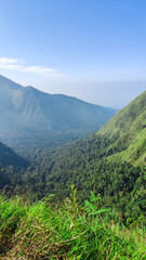 Fototapeta premium green hill with beautiful natural scenery at sembalun village lombok, indonesia. the landscape is for hiking and outdoor lifestyle concept.