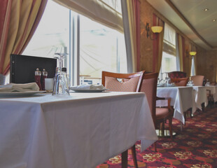 Elegant ocean view dining room a la carte restaurant onboard luxury cruiseship or cruise ship liner...