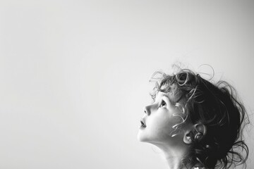 Fototapeta premium Child Looking Upwards in Black and White Profile Shot