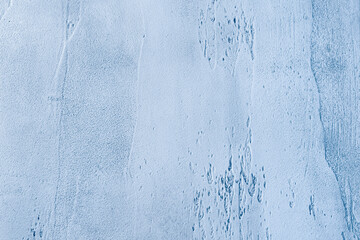 Blue textured concrete background with light base darker in the recesses. Abstract texture for graphic design or wallpaper