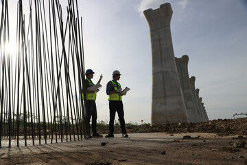 Pile Construction, Civil engineer working with blueprint drawing at steel frame for pile...