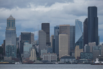 Breathtaking panoramic view onto Seattle skyline downtown highrise scenery with harbor port buildings, coastal nature landscape and maritime traffic