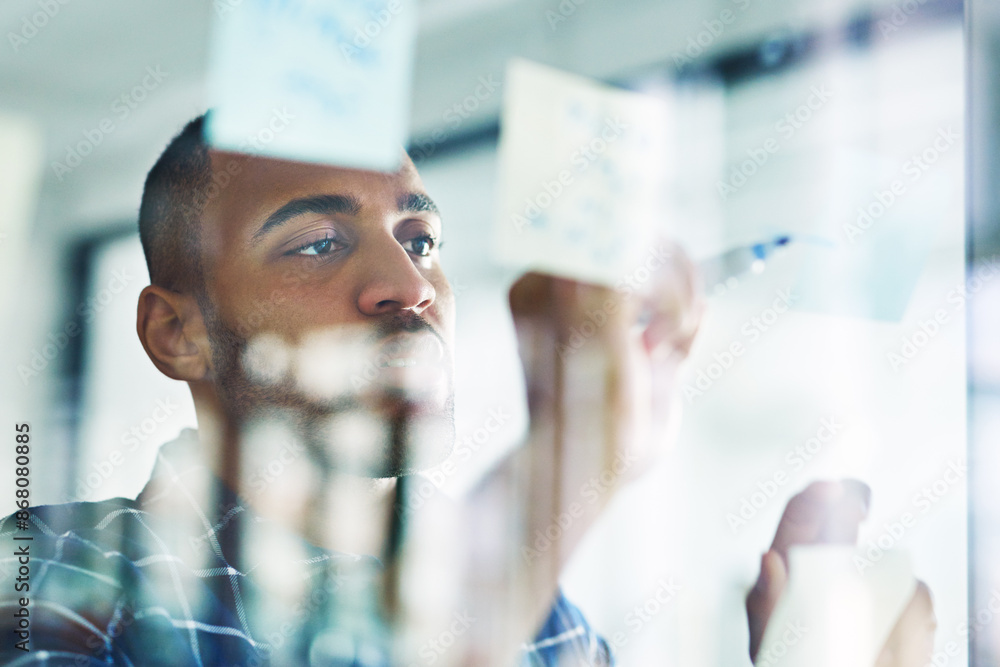 Poster Planning, writing and black man on glass wall for business, schedule or brainstorming startup idea. Sticky note, creative or problem solving for solution, mind map or web designer on software project