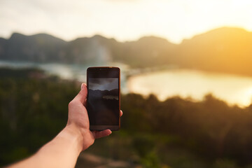 Phone screen, photograph and hands on mountain for landscape, update and post for social media. Nature, person and environment with technology for sunset, summer and adventure or holiday in Thailand
